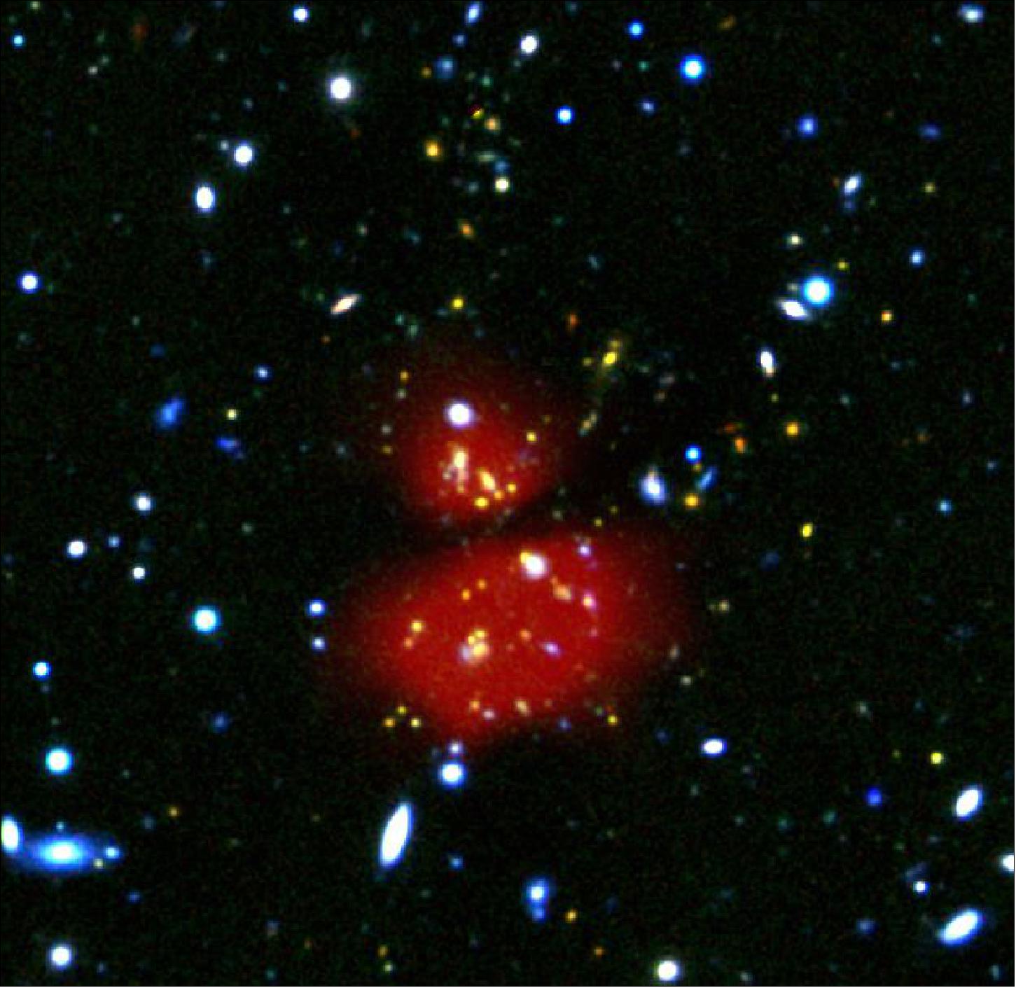 Figure 55: This composite image of Herschel depicts infrared emission from a 2 arcmin by 2 arcmin region centered on the galaxy cluster XDCPJ0044.0-2033 (image credit: ESA/Herschel/J. Santos et al. 2015; NAOJ/Subaru; ESA/VLT/Hawk-I)