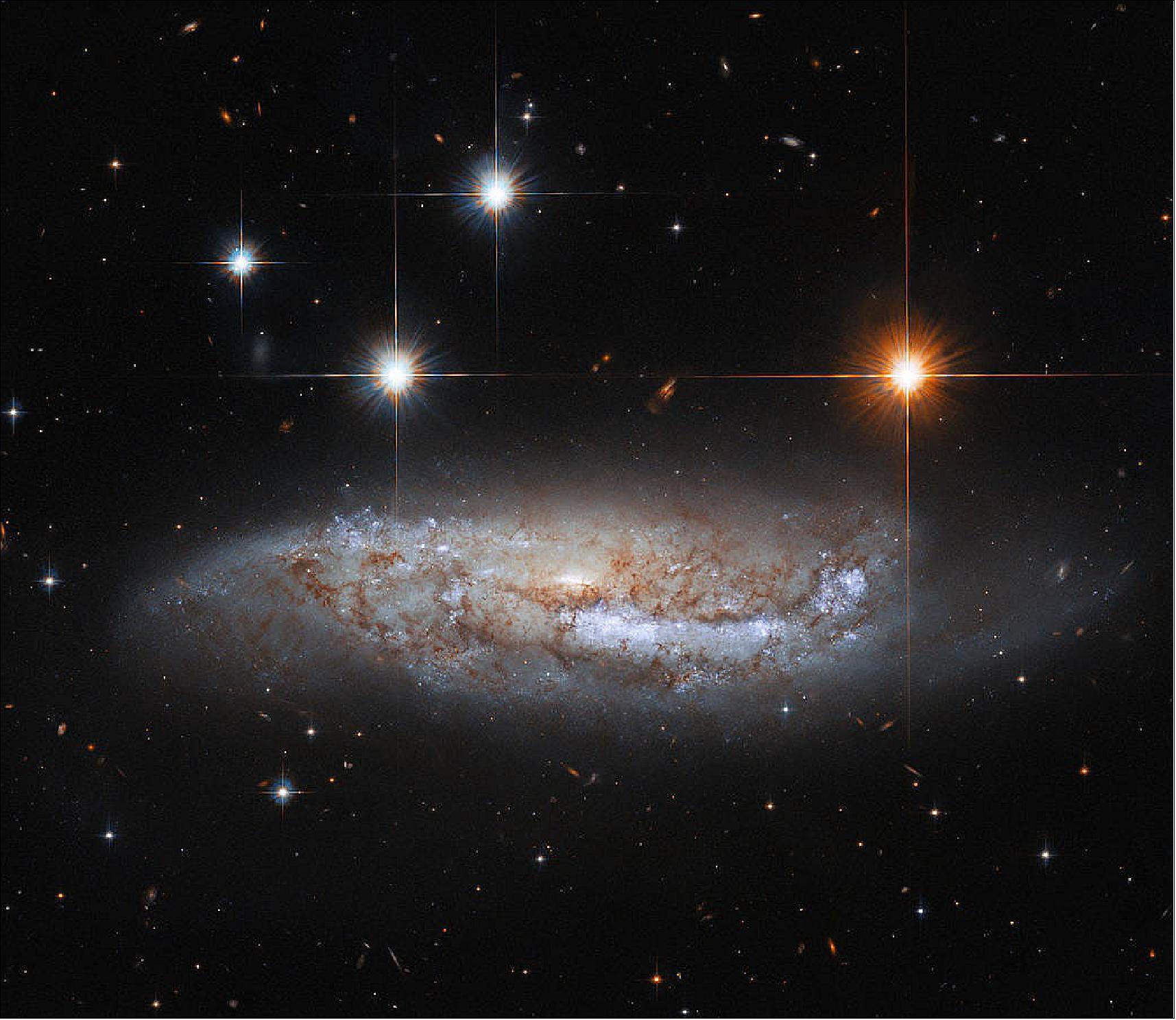Figure 86: In this image, the NASA/ESA Hubble Space Telescope captures a side-on view of NGC 3568, a barred spiral galaxy roughly 57 million light-years from the Milky Way in the constellation Centaurus. In 2014 the light from a supernova explosion in NGC 3568 reached Earth – a sudden flare of light caused by the titanic explosion accompanying the death of a massive star. While most astronomical discoveries are the work of teams of professional astronomers, this supernova was discovered by amateur astronomers who are part of the Backyard Observatory Supernova Search in New Zealand. Dedicated amateur astronomers often make intriguing discoveries – particularly of fleeting astronomical phenomena such as supernovae and comets (image credit: ESA/Hubble & NASA, M. Sun, text credit: ESA)