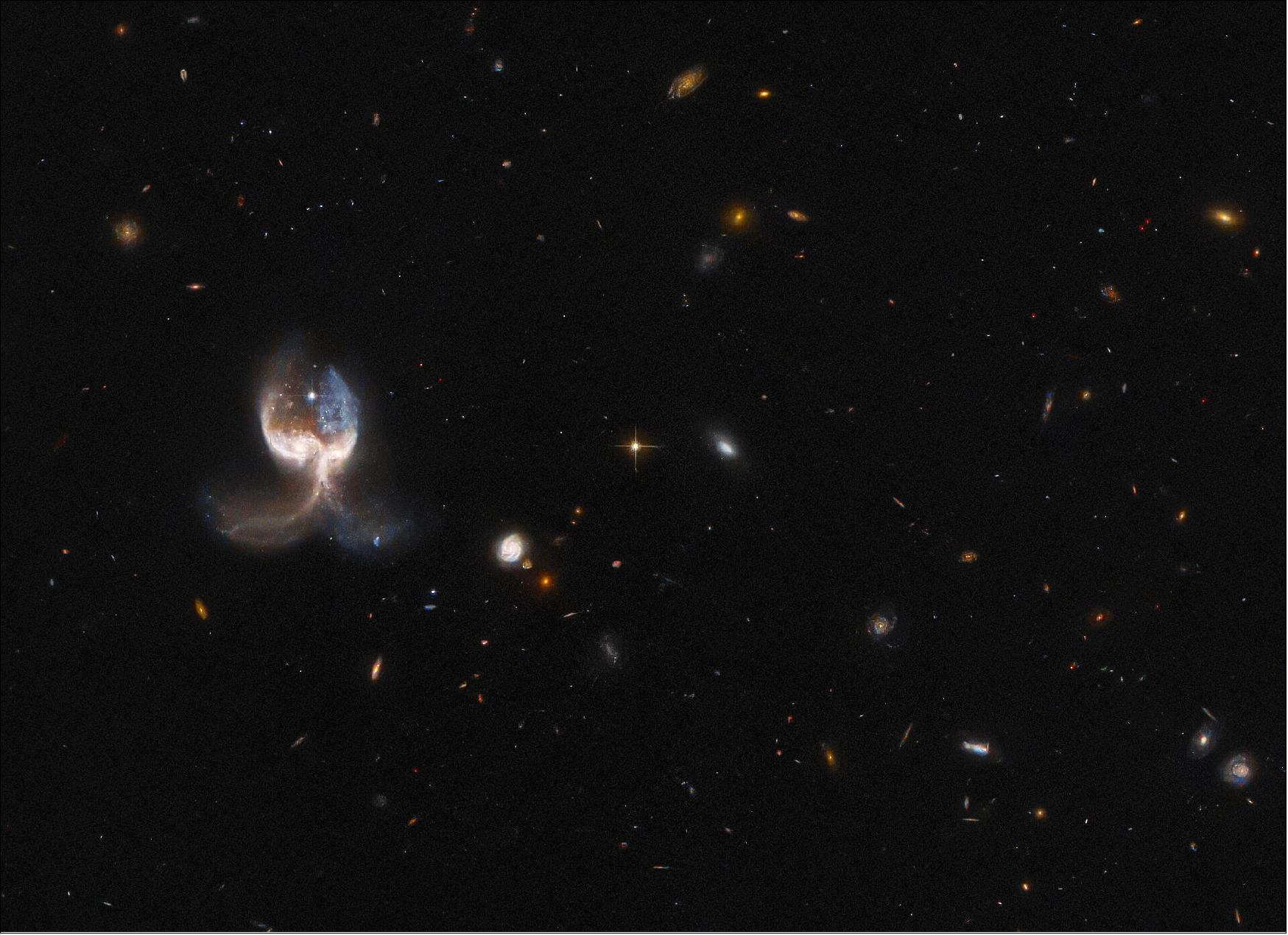 Figure 51: This angelic image comes from a set of Hubble observations inspecting the highlights of the Galaxy Zoo citizen science project. This crowdsourced astronomy project relied on hundreds of thousands of volunteers to classify galaxies and help astronomers wade through a deluge of data from robotic telescopes. In the process, volunteers discovered a rogues’ gallery of weird and wonderful galaxy types, some of which had not previously been studied. A similar, ongoing project called Radio Galaxy Zoo: LOFAR is using the same crowdsourcing approach to locate supermassive black holes in distant galaxies. Noteworthy objects from both projects were chosen for detailed follow-up observations with Hubble’s Advanced Camera for Surveys. In keeping with the crowdsourced nature of the Galaxy Zoo project, the targets for follow-up observations with Hubble were chosen via roughly 18,000 votes cast by the public. The selected targets include ring-shaped galaxies, unusual spirals, and a striking selection of galaxy mergers such as VV689 (image credit: ESA/Hubble & NASA, W. Keel.; CC BY 4.0 Acknowledgement: J. Schmidt)