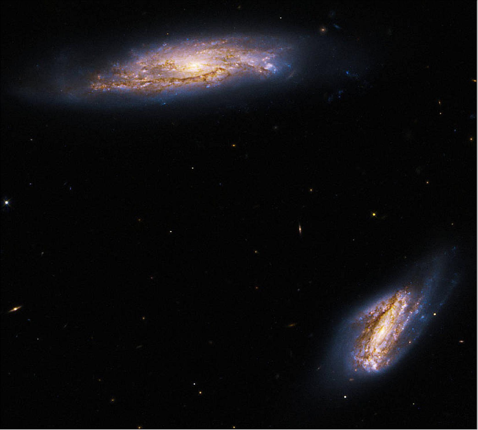 Figure 28: The image holds data from two separate Hubble observations of Arp 303. The first used Hubble’s Wide Field Camera 3 (WFC3) to study the pair’s clumpy star-forming regions in infrared light. Galaxies like IC 563 and IC 564 are very bright at infrared wavelengths and host many bright star-forming regions. The second used Hubble’s Advanced Camera for Surveys (ACS) to take quick looks at bright, interesting galaxies across the sky. The observations filled gaps in Hubble’s archive and looked for promising candidates that Hubble, the James Webb Space Telescope, and other telescopes could study further. The colors red, orange, and green represent infrared wavelengths taken with WFC3, and the color blue represents ACS visible light data [image credit: NASA, ESA, K. Larson (STScI), and J. Dalcanton (University of Washington); Image Processing: G. Kober (NASA Goddard/Catholic University of America)]
