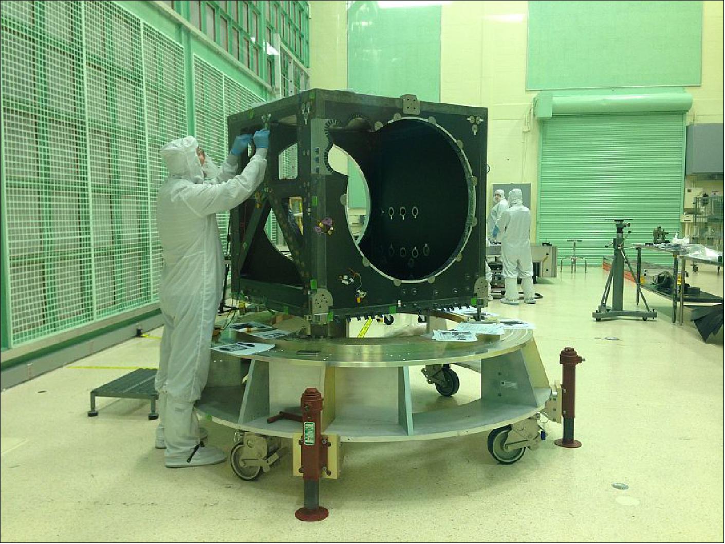 Figure 7: An engineer checks the ATLAS box structure, shortly after its arrival in a NASA clean room in May 2014 (image credit: NASA, Kate Ramsayer)
