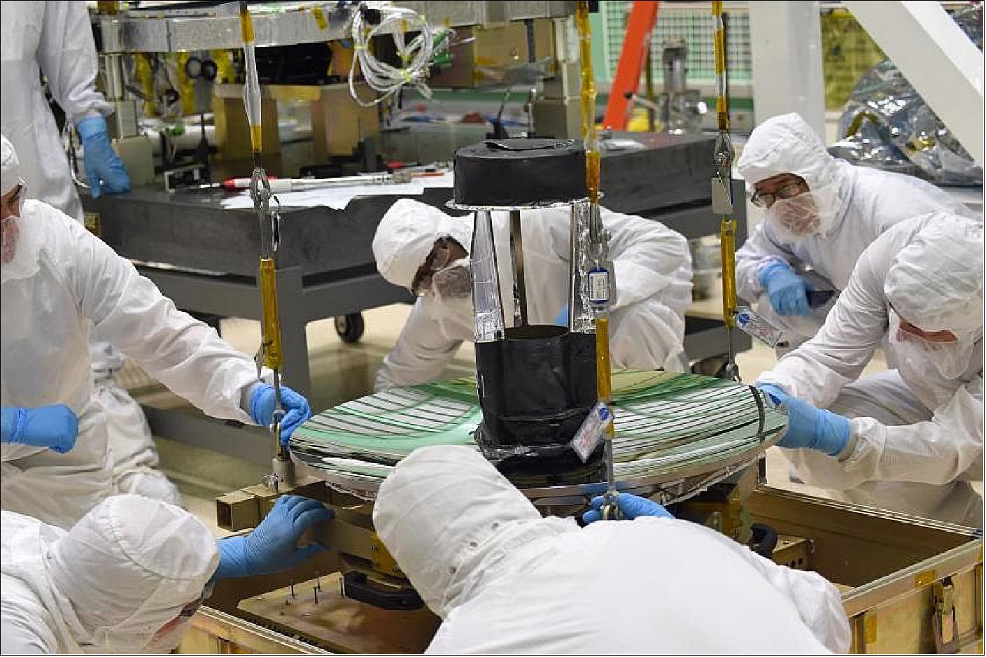 Figure 6: Engineers and technicians check the fit of ICESat-2's telescope to its sling, before moving it into place on the instrument's optical bench (image credit: NASA)