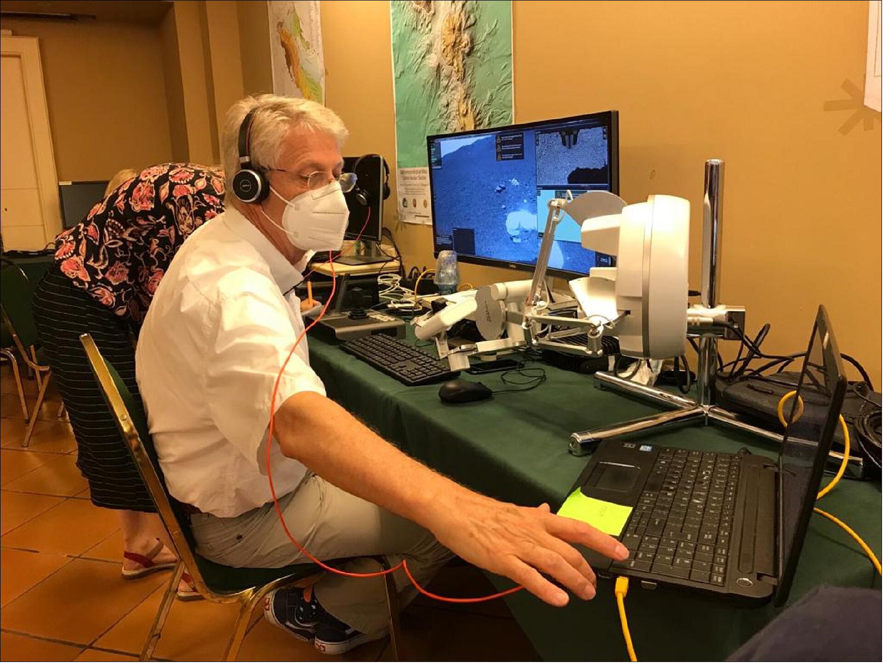 Figure 7: ESA astronaut Thomas Reiter controlled the Interact rover from a hotel room in Catania, Sicily, some 23 km and 2,600 m altitude from the rover on the slopes of Mount Etna (image credit: ESA) 2)