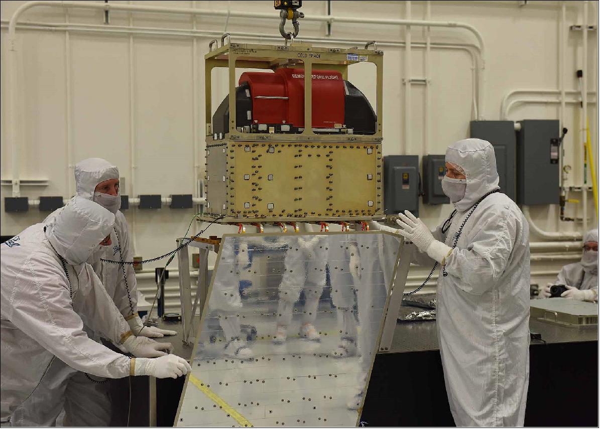 Figure 15: Ball Aerospace technicians lower the ATMS instrument onto the JPSS-1 spacecraft (image credit: BATC)