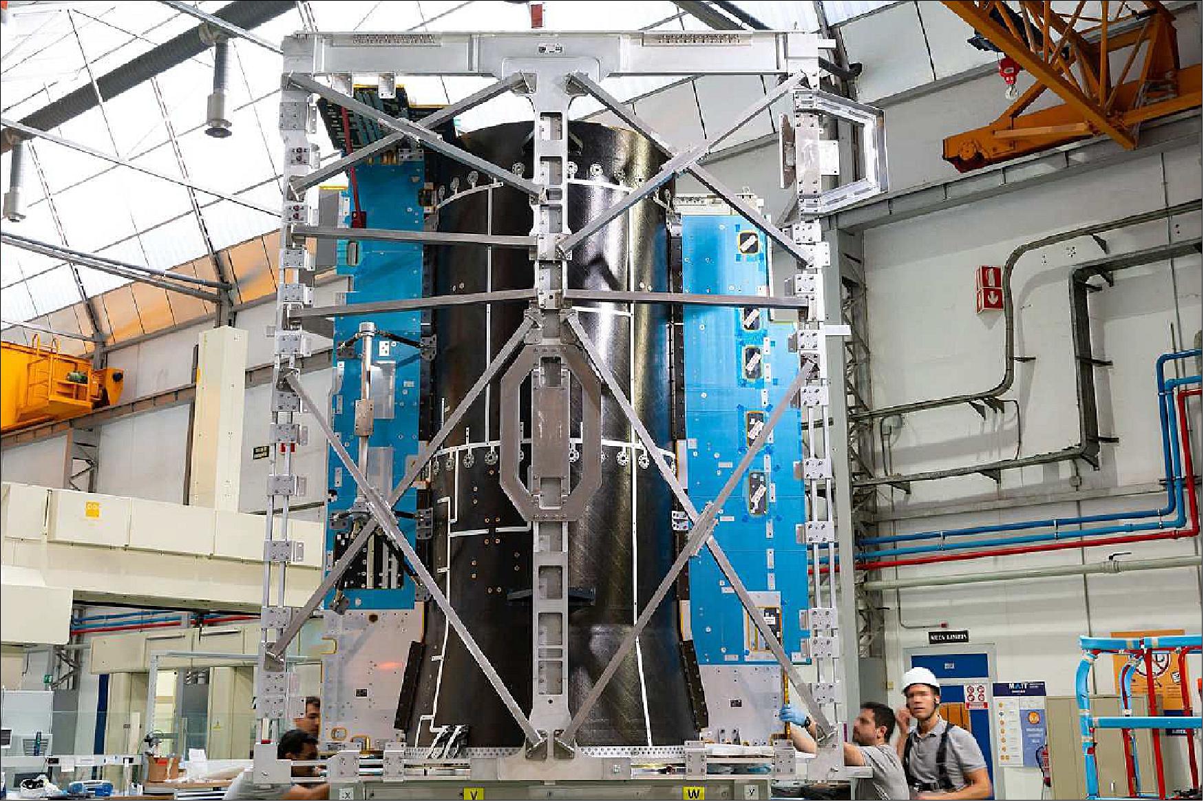 Figure 3: In July 2019, Airbus has completed the first step in the construction of the inner structure of ESA's JUICE satellite. The inner structure or SSTS (Structure, Shielding and Thermal control Subsystem), built at the Madrid-Barajas site of Airbus, is carbon fibre and is composed of the central load carrying cylinder, shear panels, two equipment protecting Vaults, the TCS (Thermal Control System) which includes a heat pipes network and multilayer insulation, and secondary elements such as 13 additive manufacturing brackets. This key element weighs 580 kg and will support the satellite's weight of 5,300 kg (of which about 3,000kg is chemical propellant). Jupiter's distance from the Sun will make it challenging to generate energy. For this reason the spacecraft is equipped with solar arrays with a total surface of 85 m2, the largest ever built for any interplanetary spacecraft (image credit: Airbus DS) 10)