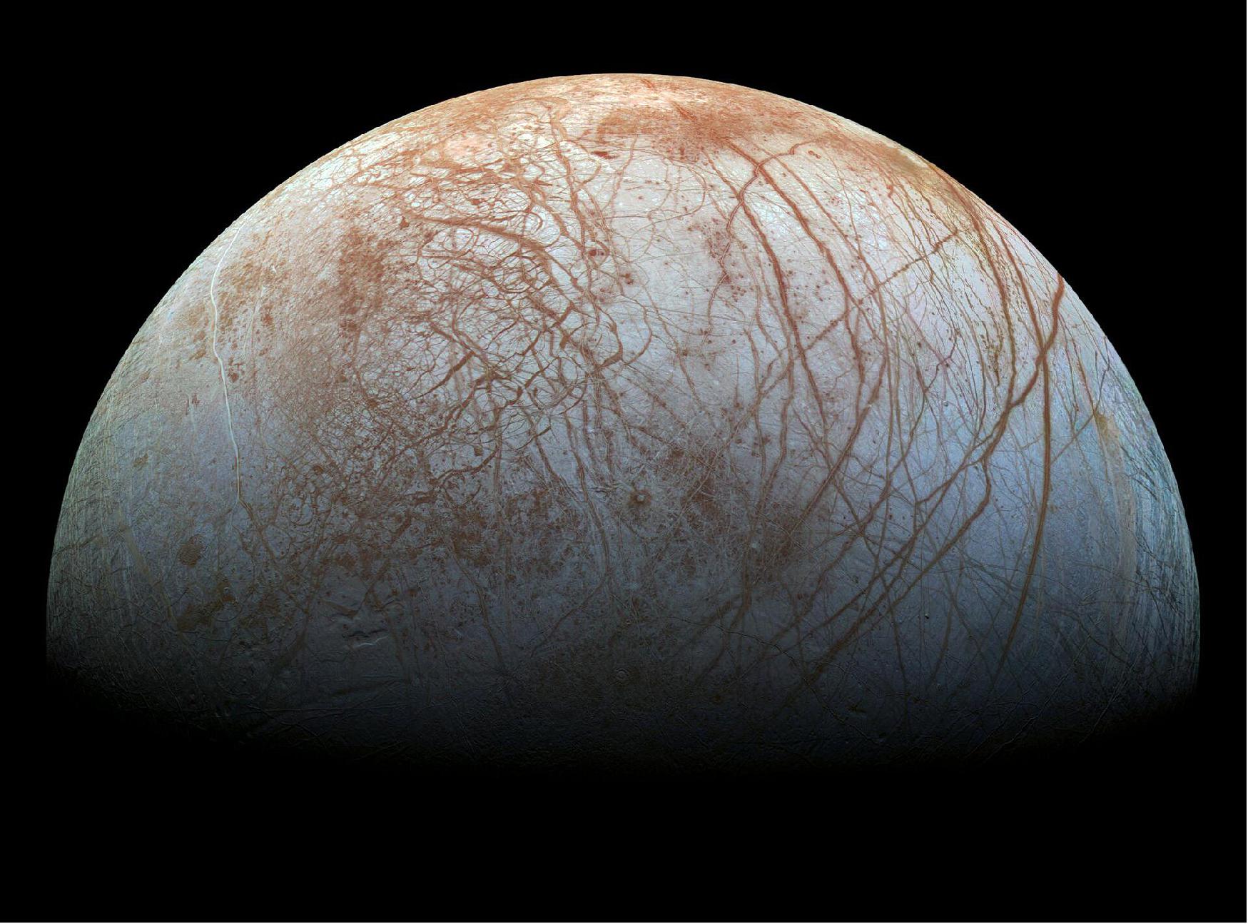 Figure 1: The scars seen in this view of the moon (Europa) from the archives of NASA's Galileo mission – based on images taken by the spacecraft in the 1990s – are a series of long cracks in its icy surface, thought to arise as Jupiter tugs at Europa and breaks the ice apart. The colors visible across the moon's surface are representative of the surface composition and size of the ice grains: reddish-brown areas, for instance, contain high proportions of non-ice substances, while blue-white areas are relatively pure (image credit: NASA/JPL-Caltech/SETI Institute)