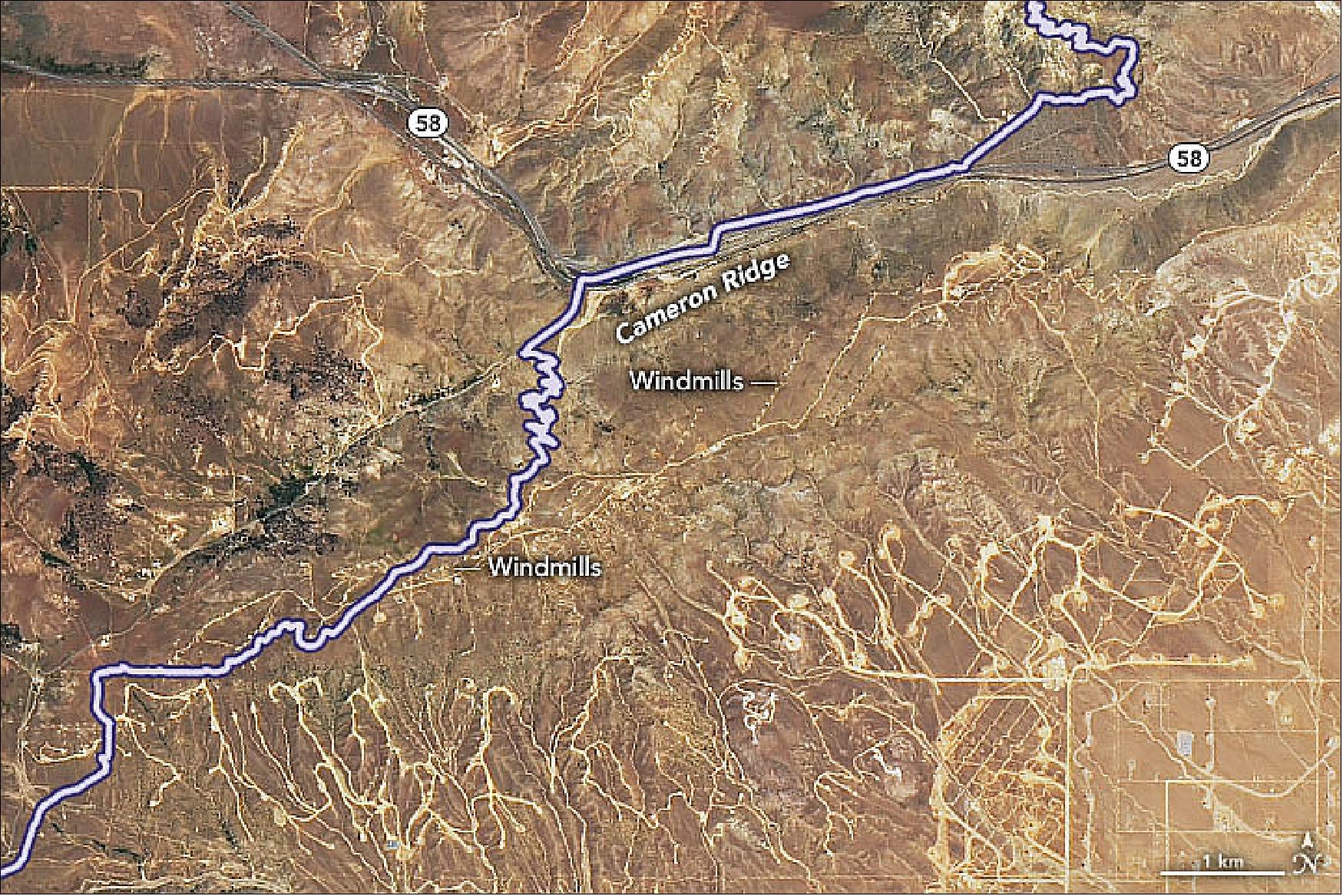 Figure 35: On 1 July 2019, the Operational Land Imager (OLI) on Landsat-8 acquired this image of Cameron Ridge where the PCT (purple) crosses Tehachapi Pass. The pass divides the Tehachapi Mountains (south) and the Sierra Nevada (north), and forms a narrow connection between the San Joaquin Valley and the Mojave Desert (image credit: NASA Earth Observatory, image by Joshua Stevens, using Landsat data from the U.S. Geological Survey. Story by Kathryn Hansen)