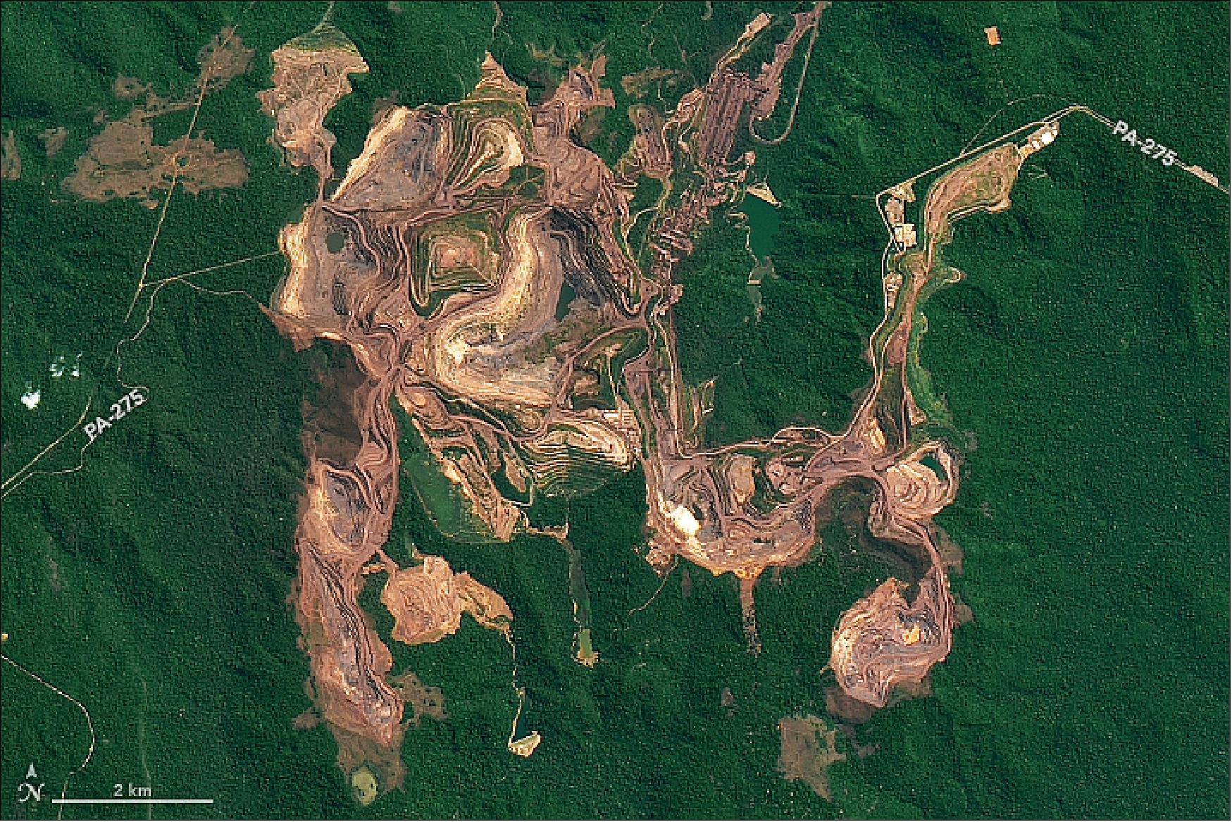 Figure 105: The red-brown earth exposed by open pit mines contrast with the greens of the surrounding Amazon forest. The image was acquired on 16 July 2018 with OLI (image credit: NASA Earth Observatory, image by Joshua Stevens, using Landsat data from the U.S. Geological Survey. Story by Kathryn Hansen)