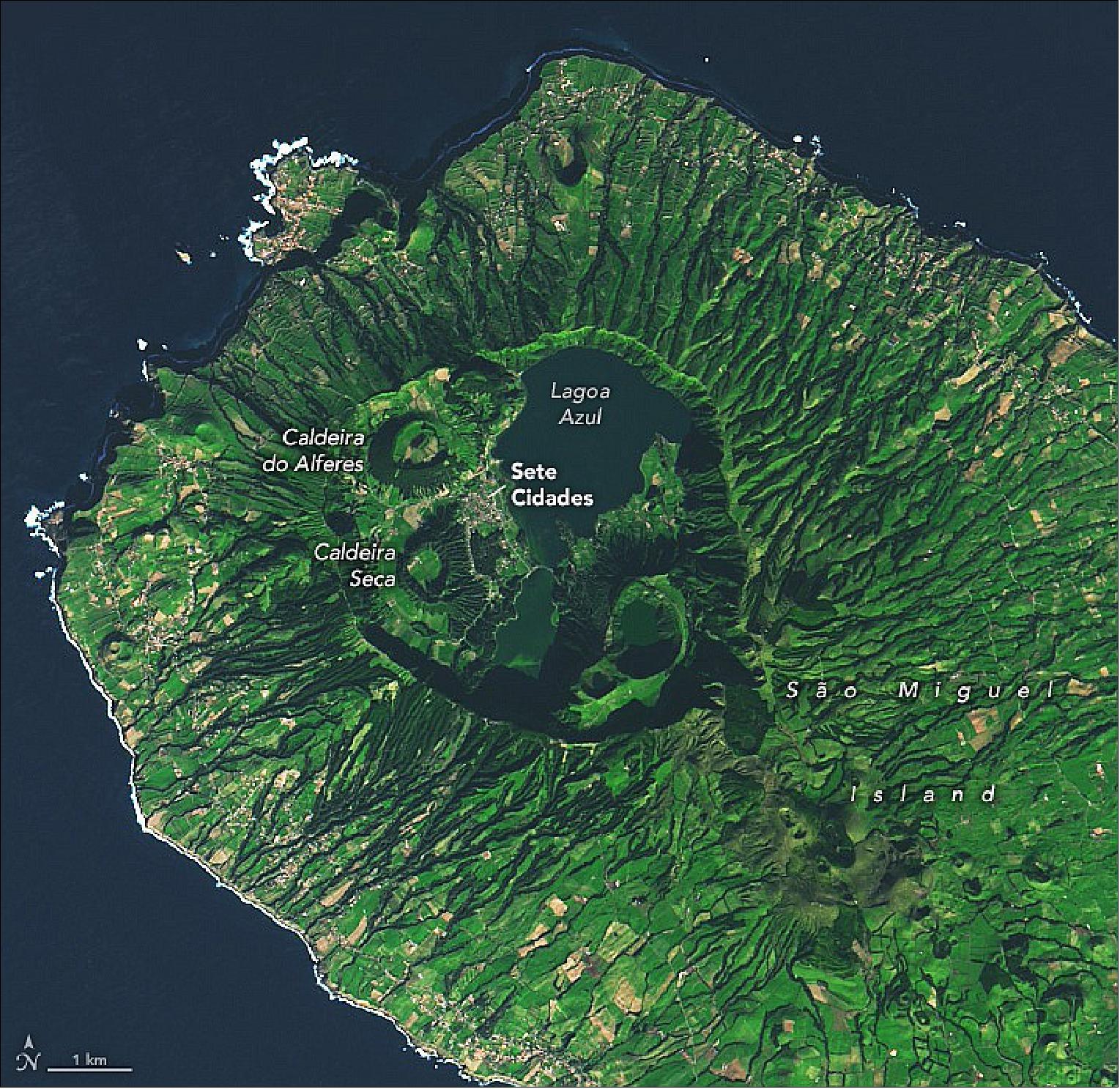 Figure 20: In this detailed view, a series of smaller volcanic cones and two lakes are visible inside the caldera of Sete Cidades. The summit caldera, about 5 km (3 miles) wide and 400 m (1,300 feet) deep, formed when the summit collapsed about 22,000 years ago. Two other volcanic cones also appear in the image: Caldeira do Alfreres, which formed during an eruption around 2050 BCE, and Caldeira Seca, which last erupted in 1444 (image credit: NASA Earth Observatory)