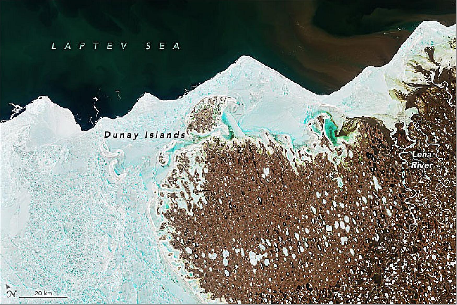 Figure 16: Some of that suspended sediment is visible flowing from beneath an ice shelf at the top right of this image acquired June 17, 2022, by the Operational Land Imager-2 (OLI-2) on Landsat 9. Also visible are the Dunay Islands. Lying off the northwest coast of the delta in the Laptev Sea, these islands are encased in land-fast sea ice for up to nine months of the year (image credit: NASA Earth Observatory image by Joshua Stevens, using Landsat data from the U.S. Geological Survey. Story by Sara E. Pratt)