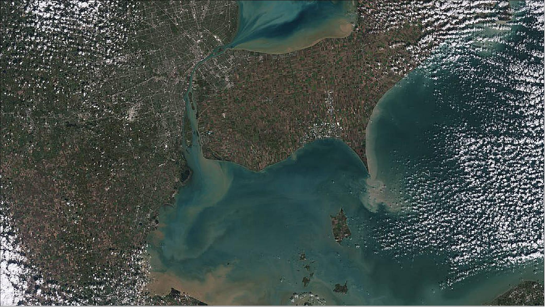 Figure 51: Sediments swirl in Lake Erie and Lake St. Clair in this Landsat 9 image of both Detroit, Michigan, and Windsor, Ontario, from Oct. 31, 2021. The Great Lakes serve as sources of freshwater, recreational activity, transport, and habitat for the upper-midwestern United States, and water quality remains a high priority. In warmer months, Landsat-9 observes swirls of green algae which can become harmful algal blooms. Landsat-9 will be able to help scientists and resource managers identify those blooms early, identifying areas to test further (image credit: NASA/USGS, Michael Bock)