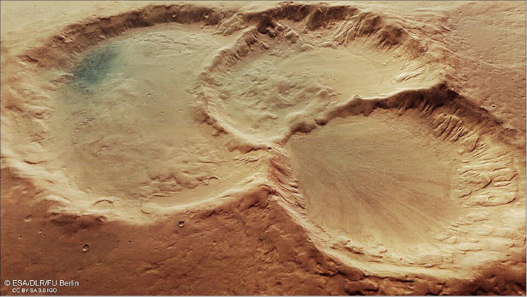 Figure 71: Perspective view of triple martian crater. This image provides a perspective view of a triple crater in the ancient martian highlands. It comprises data gathered by ESA’s Mars Express on 6 August 2020 during orbit 20982. The ground resolution is approximately 15 m/pixel and the images are centered at about 19ºE/37ºS. This image was created using data from the nadir and color channels of the High Resolution Stereo Camera (HRSC). The nadir channel is aligned perpendicular to the surface of Mars, as if looking straight down at the surface. HRSC stereo imaging was then used to derive the digital elevation model (DTM) upon which this oblique view is based (image credit: ESA/DLR/FU Berlin, CC BY-SA 3.0 IGO)