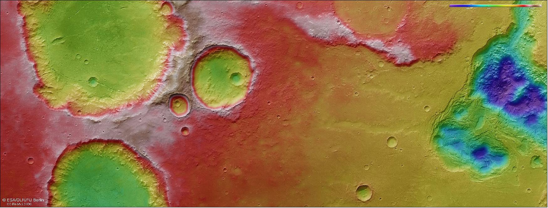 Figure 67: This color-coded topographic image shows craters, valleys and chaotic terrain in Mars’ Pyrrhae Regio, based on data gathered by the Mars Express High Resolution Stereo Camera (HRSC) during orbit 20972 (3 August 2020). This view is based on a digital terrain model (DTM) of the region, from which the topography of the landscape can be derived; lower parts of the surface are shown in blues and purples, while higher altitude regions show up in whites, yellows and reds, as indicated on the scale to the top right. North is to the right (image credit: ESA/DLR/FU Berlin, CC BY-SA 3.0 IGO)