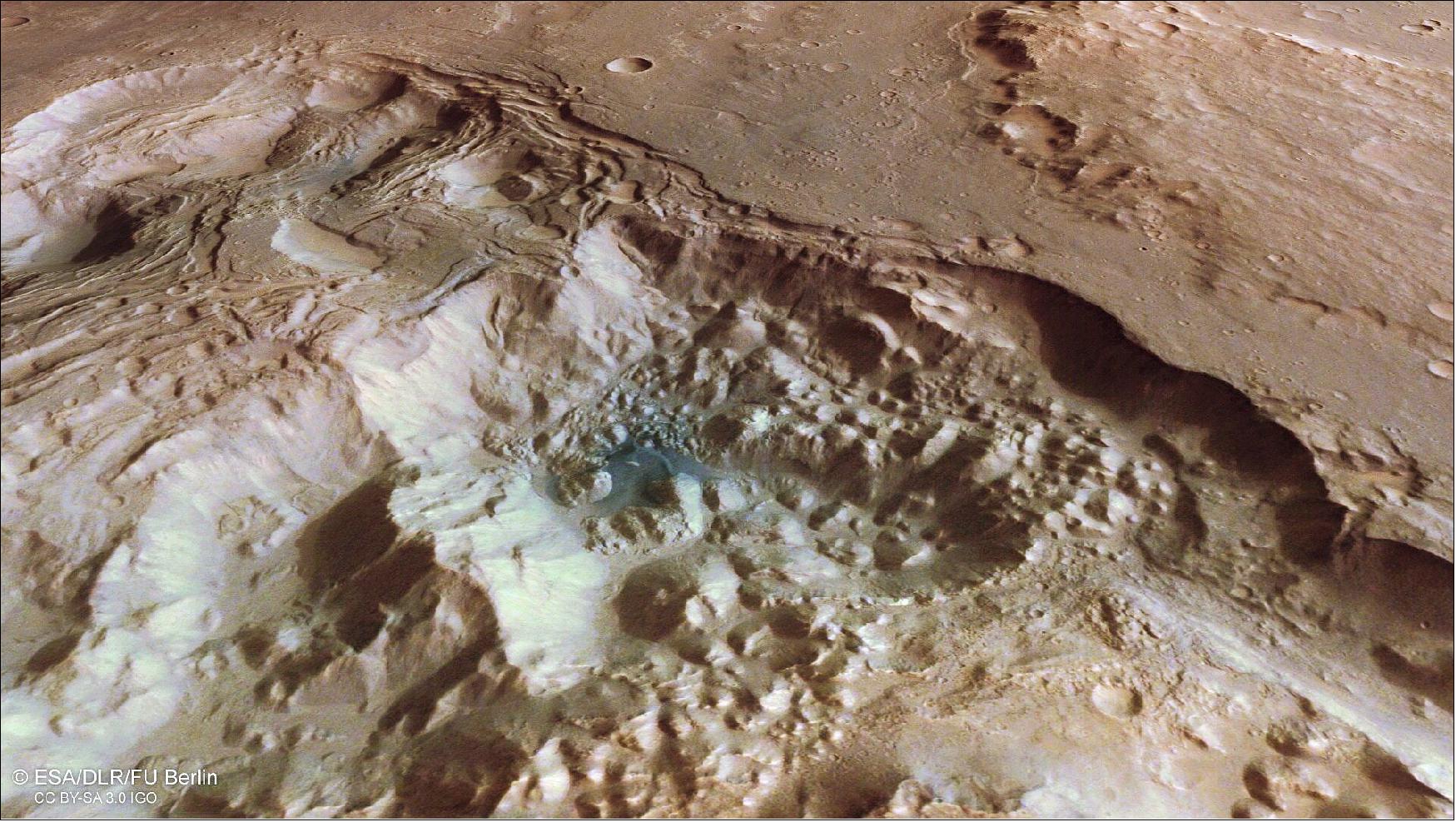 Figure 66: This image provides a perspective view of chaotic terrain in Mars’ Pyrrhae Regio. Chaotic terrain forms as a shifting subsurface layer of melting ice and sediment causes the surface above to collapse. This view comprises data gathered by ESA’s Mars Express on 3 August 2020 during orbit 20972. The ground resolution is approximately 16 m/pixel and the image is centered at about 322ºE/16ºS. This view was created using data from the nadir and color channels of the High Resolution Stereo Camera (HRSC). The nadir channel is aligned perpendicular to the surface of Mars, as if looking straight down at the surface. HRSC stereo imaging was then used to derive the digital elevation model (DTM) upon which this oblique view is based (image credit: ESA/DLR/FU Berlin, CC BY-SA 3.0 IGO)