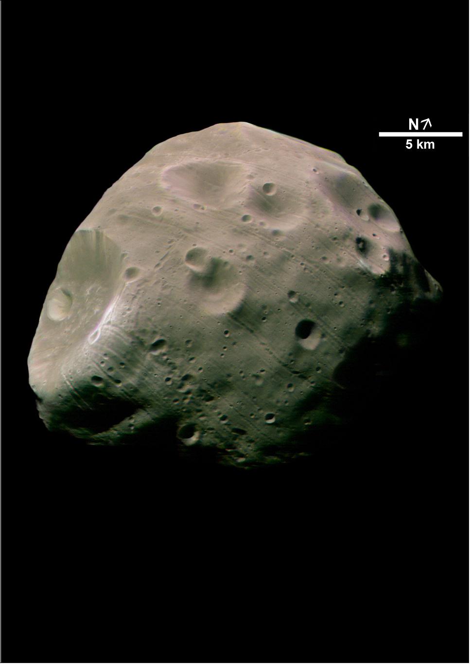 Figure 42: This image, taken by the High Resolution Stereo Camera (HRSC) on board ESA’s Mars Express spacecraft, is one of the highest-resolution pictures so far of the Martian moon Phobos. The image shows the Mars-facing side of the moon, taken from a distance of less than 200 km with a resolution of about seven meters per pixel during orbit 756, on 22 August 2004. This color image was calculated from the three color channels and the nadir channel on the HRSC. Due to geometric reasons the scale bar is only valid for the center of the image (image credit: ESA/DLR/FU Berlin (G. Neukum), CC BY-SA 3.0 IGO)