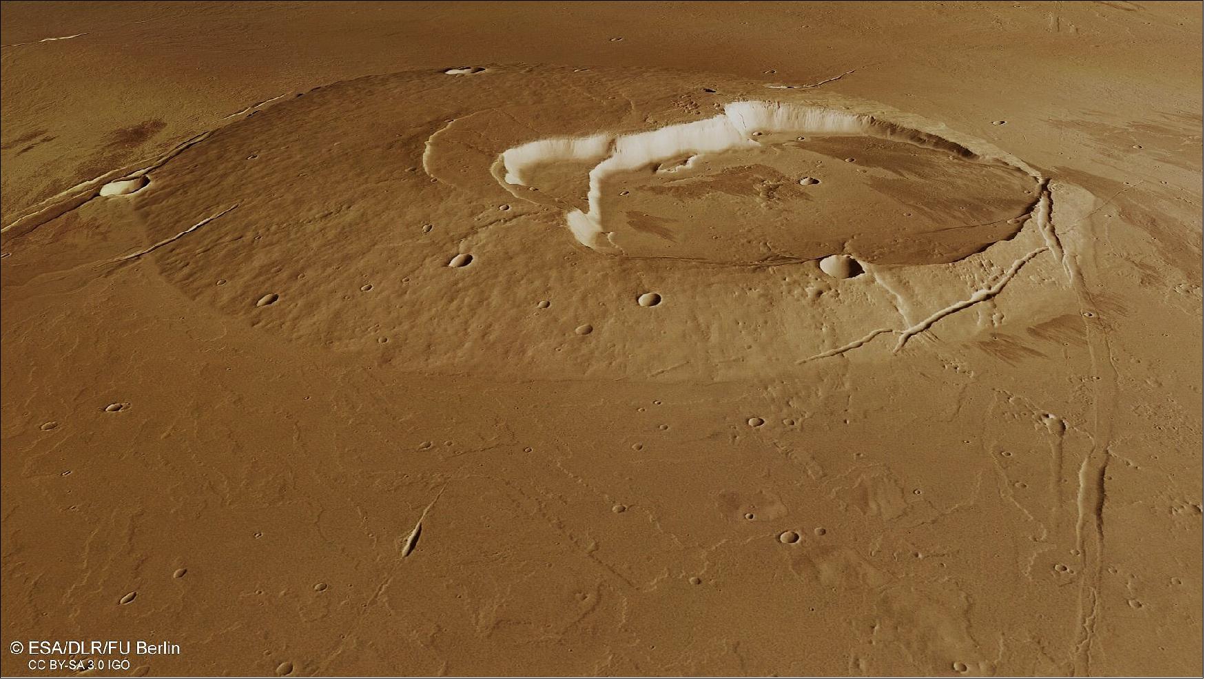 Figure 36: Second perspective view of Jovis Tholus. This oblique perspective view of the Jovis Tholus shield volcano on Mars was generated from the digital terrain model and the nadir and colour channels of the High Resolution Stereo Camera on ESA’s Mars Express. The volcano’s complex caldera system comprises at least five craters. The largest is about 28 km wide, and sits off centre. The calderas step down towards the southwest where the youngest eventually meets with the surrounding sea of even younger lava flows (image credit: ESA/DLR/FU Berlin, CC BY-SA 3.0 IGO)