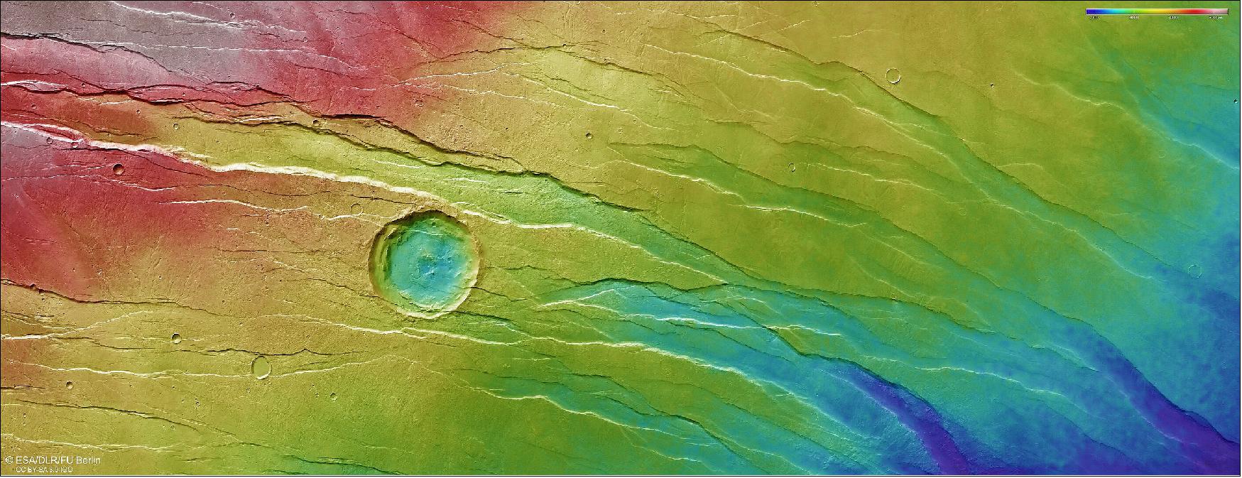 Figure 20: Topography of Tantalus Fossae. This colour-coded topographic image of Tantalus Fossae was created from data collected by ESA’s Mars Express on 19 July 2021 during orbit 22173. It is based on a digital terrain model of the region, from which the topography of the landscape can be derived. Lower parts of the surface are shown in blues and purples, while higher altitude regions show up in whites and reds, as indicated on the scale to the top right. — North is to the right. The ground resolution is approximately 18 m/pixel and the images are centred at about 43ºN/257ºE (image credit: ESA/DLR/FU Berlin, CC BY-SA 3.0 IGO)