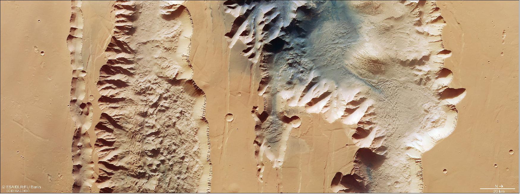 Figure 5: This image from ESA’s Mars Express shows Ius and Tithonium Chasmata, which form part of Mars’ Valles Marineris canyon structure. This image comprises data gathered by Mars Express’ High Resolution Stereo Camera (HRSC) on 21 April 2022. It was created using data from the nadir channel, the field of view aligned perpendicular to the surface of Mars, and the colour channels of the HRSC. It is a ‘true colour’ image, reflecting what would be seen by the human eye if looking at this region of Mars. - The ground resolution is approximately 25 m/pixel and the image is centred at about 272ºE/6ºS. North is to the right. Click here to see a version of this image with the main features annotated (image credit: ESA/DLR/FU Berlin, CC BY-SA 3.0 IGO)