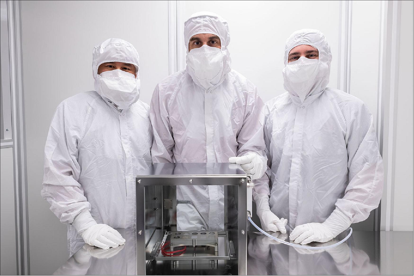 Figure 30: Image of engineers with the Mars 2020 SHERLOC Calibration Target in a clean room at NASA/JSC (Johnson Space Center). This is the first Mars flight hardware that has been designed, assembled & tested at NASA/JSC, led by Jacobs/JETS Chief Scientist Trevor Graff. It will carry the first space suit materials to Mars and will carry a piece of a martian meteorite back to the surface of Mars (image credit: NASA/JSC) 33)
