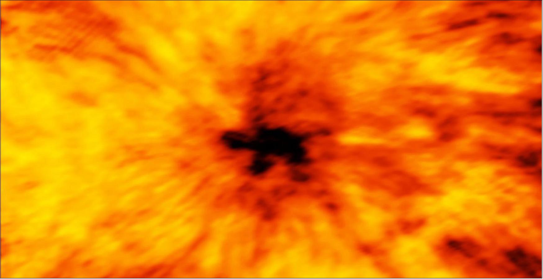 Figure 66: This ALMA image of an enormous sunspot was taken on 18 December 2015 with the Band 6 receiver at a wavelength of 1.25 mm. Sunspots are transient features that occur in regions where the Sun’s magnetic field is extremely concentrated and powerful. They are lower in temperature than their surrounding regions, which is why they appear relatively dark in visible light. The ALMA image is essentially a map of temperature differences in a layer of the Sun's atmosphere known as the chromosphere, which lies just above the visible surface of the Sun (the photosphere). The chromosphere is considerably hotter than the photosphere. Understanding the heating and dynamics of the chromosphere are key areas of research that will be addressed by ALMA. Observations at shorter wavelengths probe deeper into the solar chromosphere than longer wavelengths. Hence, band 6 observations map a layer of the chromosphere that is closer to the visible surface of the Sun than band 3 observations [image credit: ALMA (ESO/NAOJ/NRAO)]