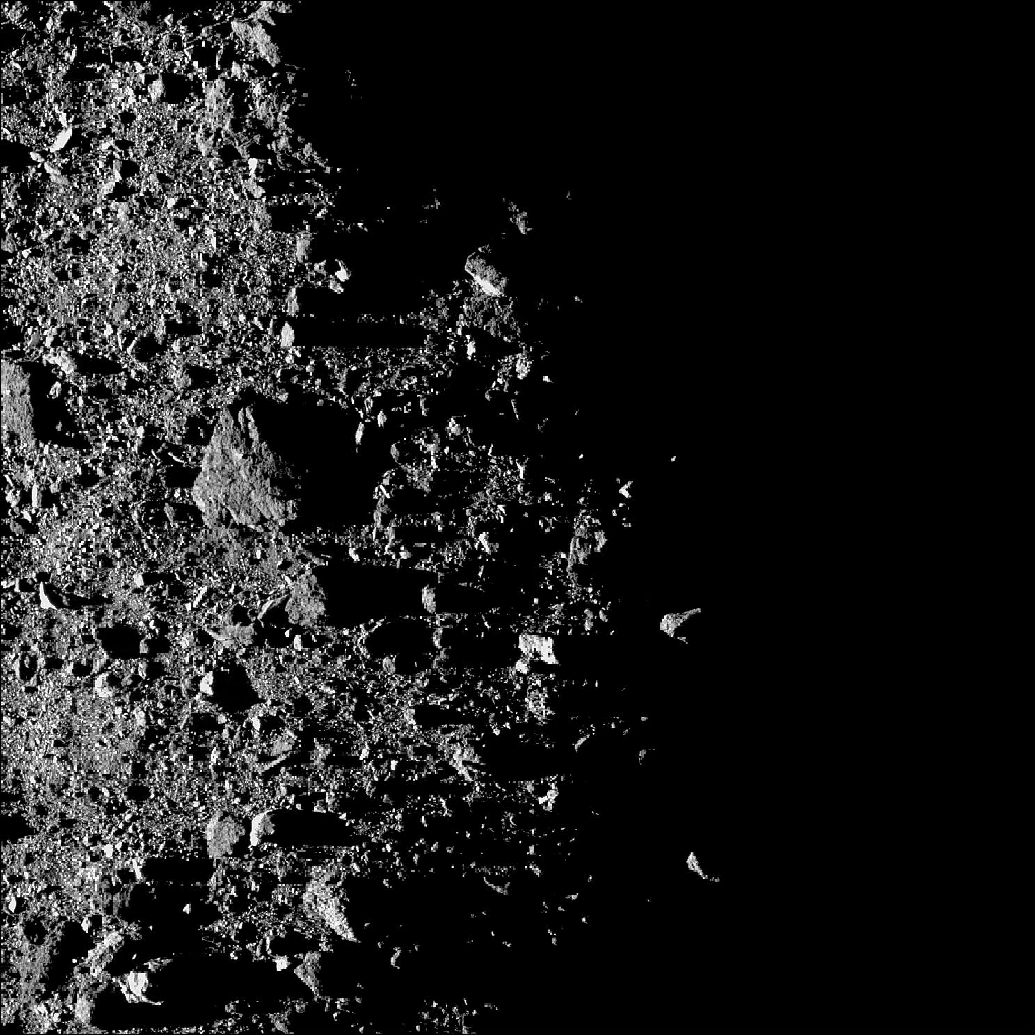 Figure 59: This image of OCAMS (MapCam) shows a region near asteroid Bennu’s north pole on the terminator line between the asteroid’s day and night sides. The OSIRIS-REx spacecraft’s MapCam camera obtained the image on Feb. 20 while in orbit around the asteroid from a distance of 1.8 km. At this distance, each pixel covers approximately 12 cm of Bennu’s surface. The largest boulder, located slightly left of the center, measures around 16 meters across, which, for scale, is the length of the trailer on a semi-truck (image credit: NASA/Goddard/University of Arizona)