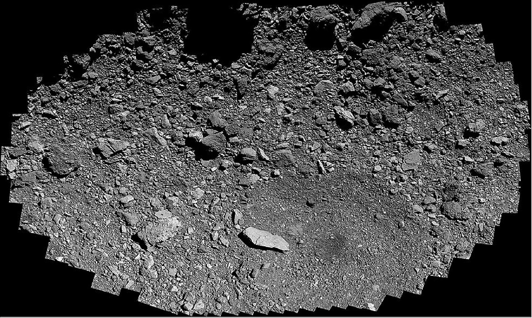 Figure 35: The sample site is located in the crater at the bottom of the image, just above the dark patch at the crater’s center. The long, light-colored boulder to the left of the dark patch, named Strix Saxum, is 17 ft (5.2 m) in length. The mosaic is rotated so that Bennu’s east is at the top of the image (image credit: NASA/Goddard/University of Arizona)