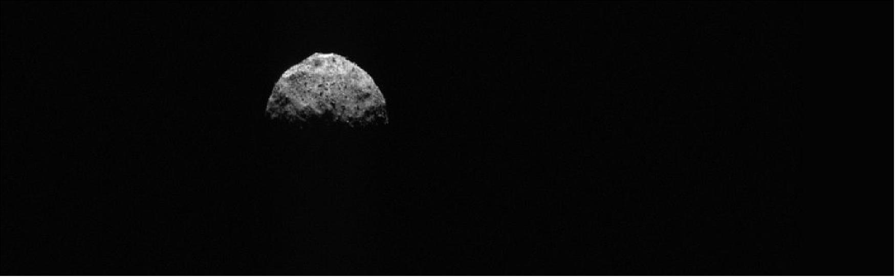 Figure 17: This image shows a top-down view of asteroid Bennu, with a portion of the asteroid’s equatorial ridge and northern hemisphere illuminated. It was taken by the PolyCam camera on NASA’s OSIRIS-REx spacecraft on March 4, 2021, from a distance of about 186 miles (300 km). The spacecraft’s cameras are pointed directly at Bennu’s north pole. Two large equatorial craters are visible on the asteroid’s edge (center and center left). The image was obtained during the mission’s Post-TAG Operations phase, as the spacecraft slowly approached Bennu in preparation for a final observational flyby on April 7 (image credit: NASA/Goddard/University of Arizona)