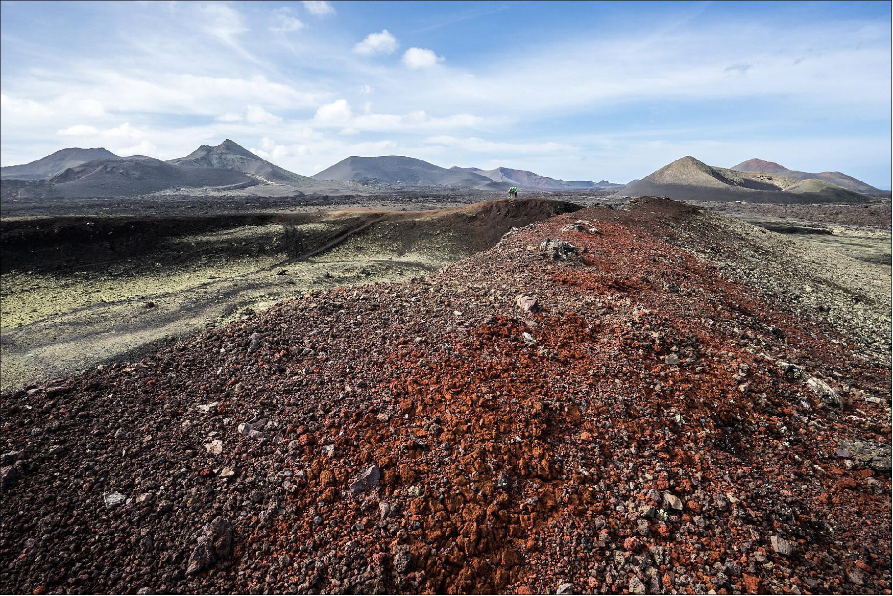 Figure 8: Volcanic landscape in Lanzarote, Spain, during ESA's Pangaea geology training. The color of soil can tell you a lot about its composition, and the paleoenvironment it was deposited in. Reddish color generally means that the rock is iron rich, and has been able to oxidize (image credit: ESA, A. Romeo)
