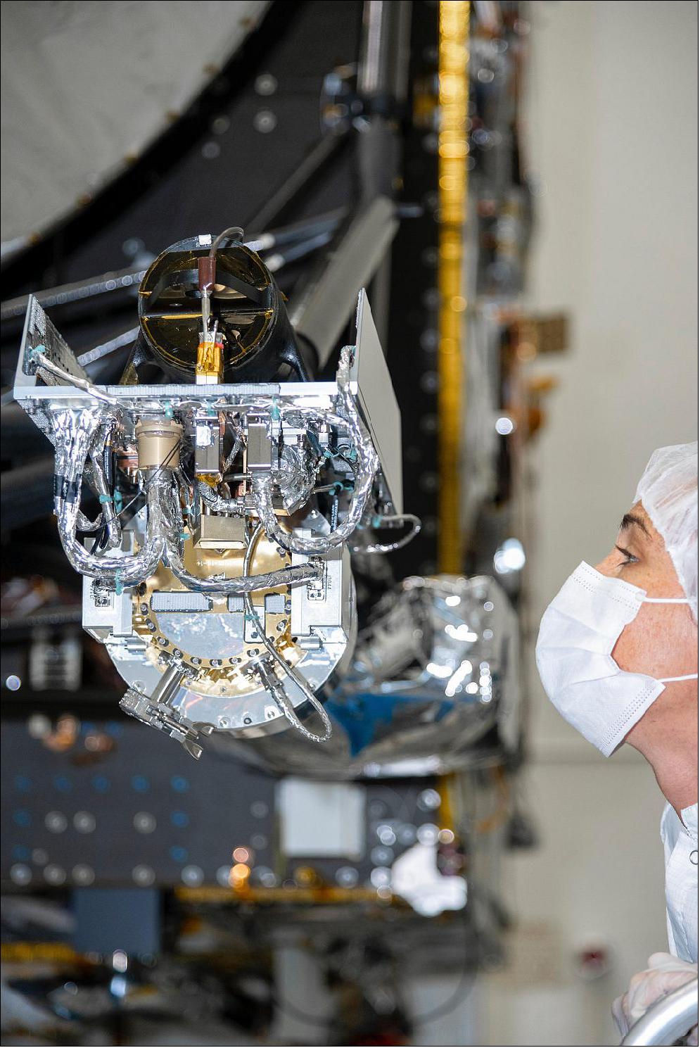 Figure 9: At NASA's Jet Propulsion Laboratory, an engineer inspects the gamma ray and neutron spectrometer as it is integrated into the agency's Psyche spacecraft. The instrument will help determine the elements that make up its target (image credit: NASA/JPL-Caltech)