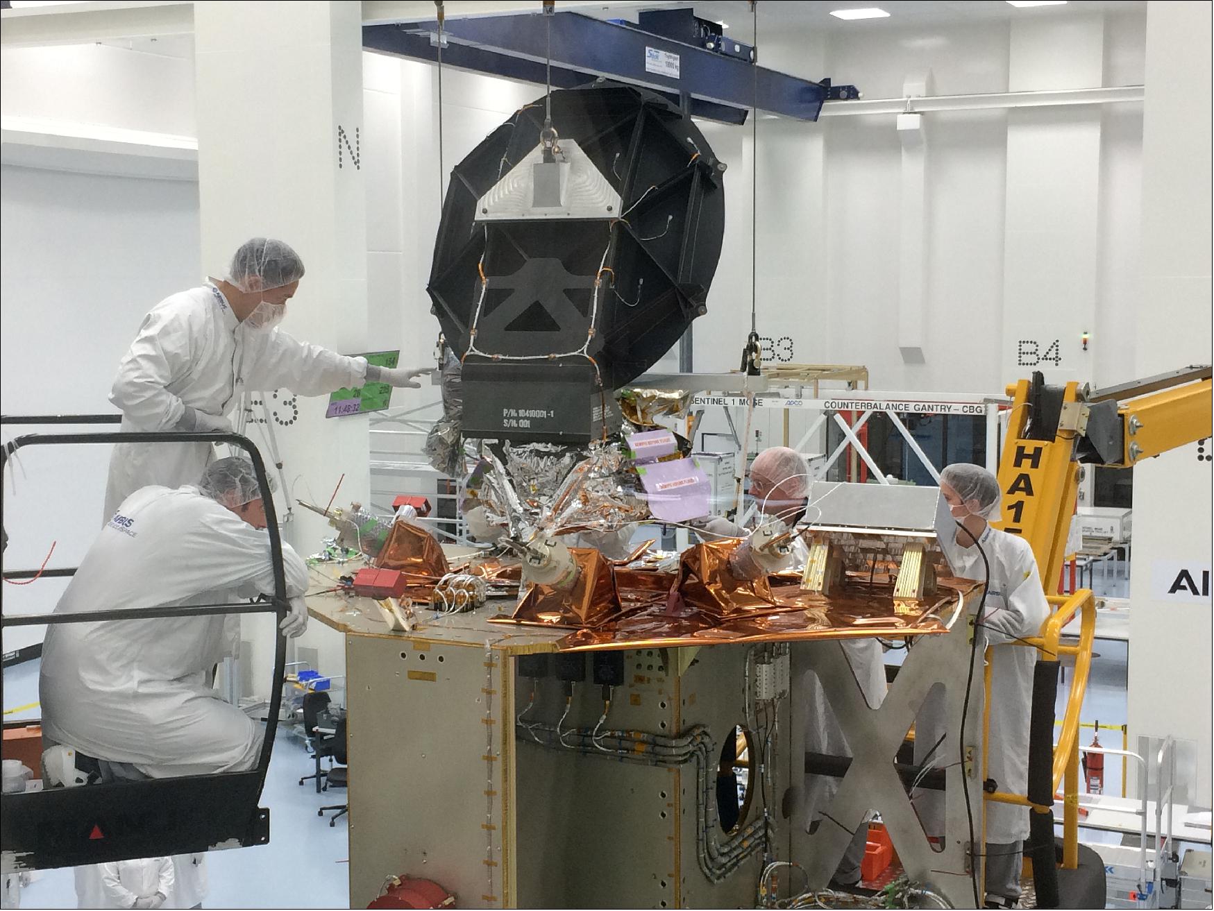 Figure 73: Copernicus Sentinel-6 radiometer integration. The AMR-C (Advanced Microwave Radiometer for Climate monitoring) is being integrated on to the Copernicus Sentinel-6A satellite. The photo shows teams at Airbus in Friedrichshafen, Germany, lowering the instrument on to the satellite prior to mechanical mounting and alignment checks. As part of the international cooperation for this mission, the radiometer has been supplied by NASA/JPL. The satellite's main instrument is a radar altimeter to measure sea-surface height. The radiometer accounts for the amount of water vapor in atmosphere, which affects the speed of the altimeter's radar pulses (image credit: Airbus)