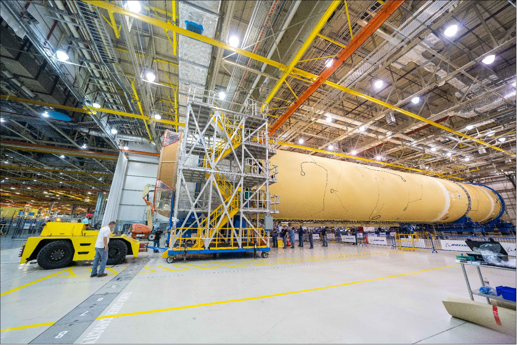 Figure 29: NASA finished assembling the main structural components for the Space Launch System (SLS) rocket core stage on Sept. 19. Engineers at NASA’s Michoud Assembly Facility in New Orleans fully integrated the last piece of the 212-foot-tall (64.6 m) core stage by adding the engine section to the rest of the previously assembled structure. Boeing technicians bolted the engine section to the stage’s liquid hydrogen propellant tank. The engine section is located at the bottom of the 212-foot-tall core stage and is one of the most complicated pieces of hardware for the SLS rocket. It is the attachment point for the four RS-25 rockets and the two solid rocket boosters that produce a combined 8.8 millions pounds of thrust (35585 kNewton) to send Artemis I to space. In addition, the engine section includes vital systems for mounting, controlling and delivering fuel from the stage’s two liquid propellant tanks to the rocket’s engines. This fall, NASA will work with core stage lead contractor, Boeing, and the RS-25 engine lead contractor, Aerojet Rocketdyne, to attach the four RS-25 engines and connect them to the main propulsion systems inside the engine section (image credit: NASA, Steven Seipel)
