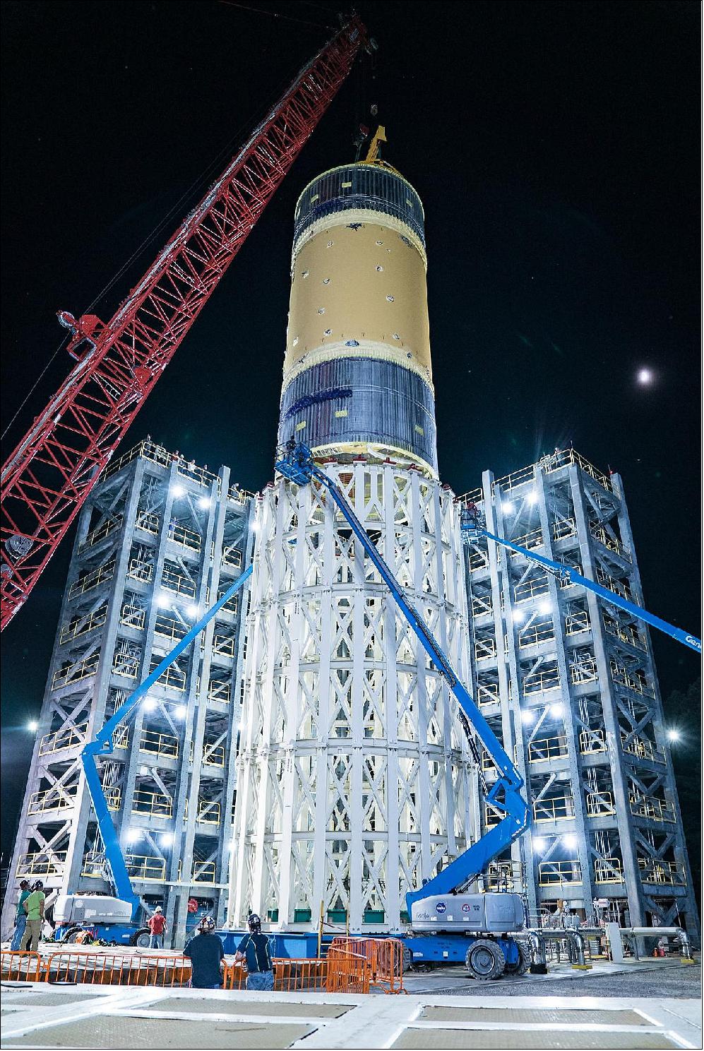 Figure 22: The liquid oxygen tank structural test article, shown here, for NASA’s Space Launch System (SLS) rocket’s core stage was the last test article loaded into the test stand July 10, 2019. The liquid oxygen tank is one of two propellant tanks in the rocket’s massive core stage that will produce more than 2 million pounds of thrust to help launch Artemis-1, the first flight of SLS and NASA’s Orion spacecraft to the Moon. Now, the tank will undergo the final test completing a three-year structural test campaign at NASA’s Marshall Space Flight Center in Huntsville, Alabama. Tests conducted during this campaign put the rocket’s structures from the top of the upper stage to the bottom of the core stage through strenuous tests simulating the forces that the rocket will experience during launch and flight. All four of the core stage structural test articles were manufactured at NASA’s Michoud Assembly Facility in New Orleans and delivered by NASA’s barge Pegasus to Marshall (image credit: NASA/Tyler Martin)