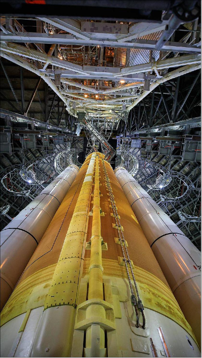 Figure 13: NASA has completed the design certification review (DCR) for the Space Launch System Program (SLS) rocket ahead of the Artemis I mission to send the Orion spacecraft to the Moon. This close-up view shows the SLS rocket for Artemis I inside High Bay 3 of the Vehicle Assembly Building (VAB) at NASA’s Kennedy Space Center in Florida on Sept. 20, 2021. Inside the VAB, the rocket recently completed the umbilical retract and release test and the integrated modal test. With the completion of the SLS design, NASA has now certified the SLS and Orion spacecraft designs, as well as the new Launch Control Center at Kennedy for the Artemis I mission (image credit: NASA/Frank Michaux)