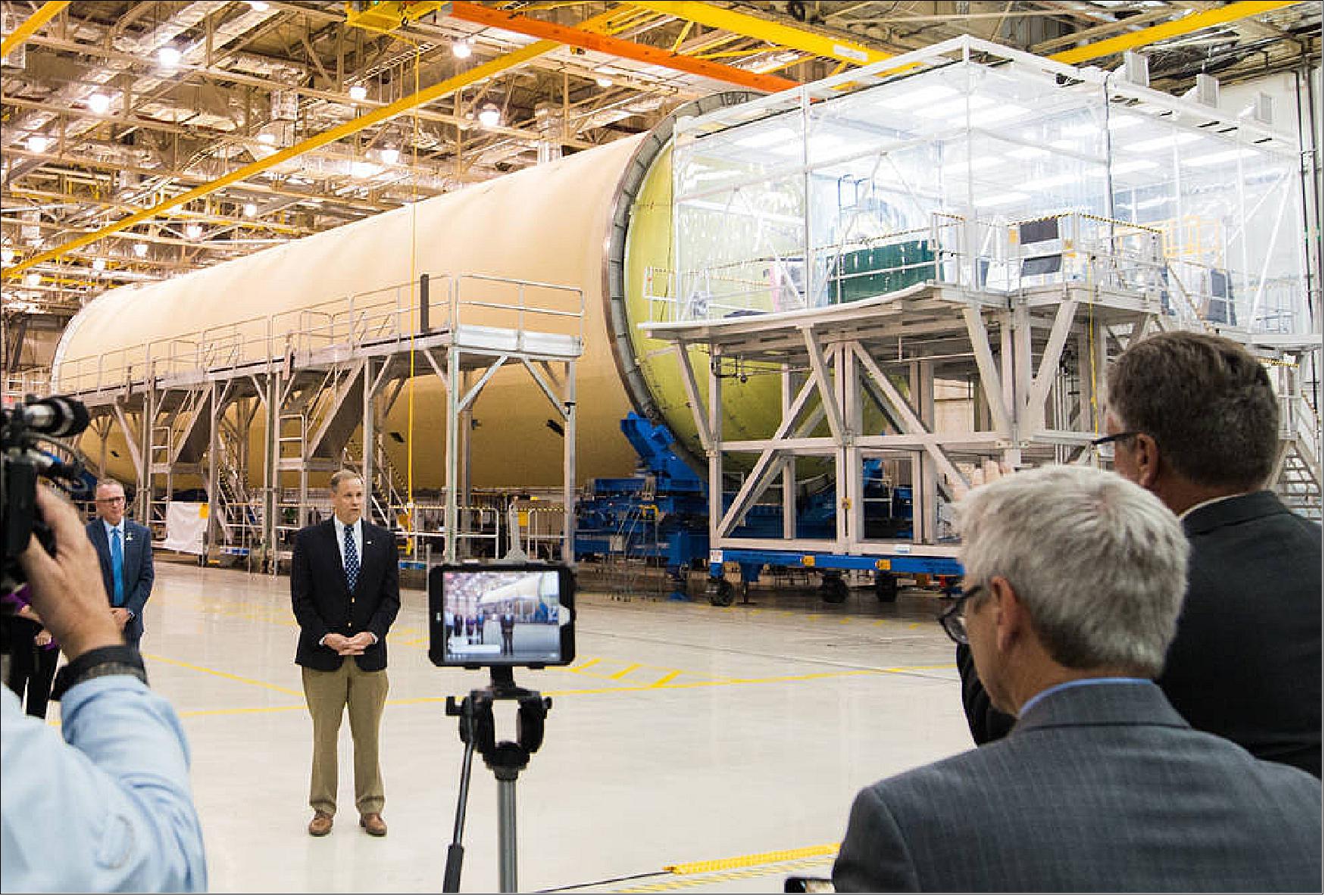 Figure 46: NASA Administrator Jim Bridenstine speaks with members of the media in front of the massive liquid hydrogen tank, which comprises almost two-thirds of the core stage and holds 537,000 gallons (2032 cm3) of liquid hydrogen cooled to minus 423º Fahrenheit (-252ºC). Innovative processes are part of core stage manufacturing including joining the thickest pieces of aluminum ever with self-reacting friction stir welding. The liquid oxygen tank and liquid hydrogen tanks have the thickest joints ever made with self-reacting friction stir welding (image credit: NASA, Jude Guidry)