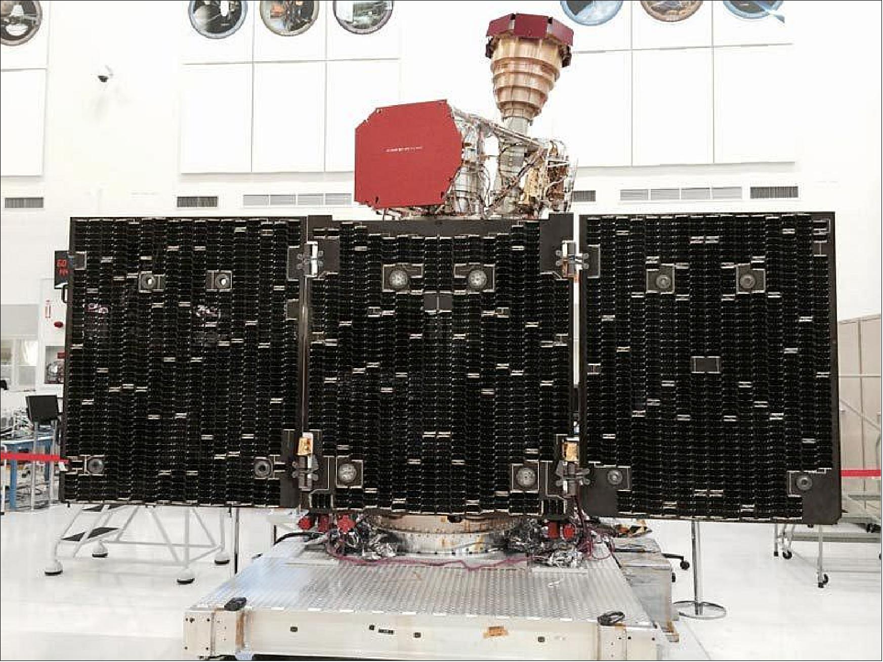 Figure 7: The unfolded solar arrays to power SMAP and the golden feedhorn for its radar and radiometer are visible in this image taken during assembly and testing (image credit: NASA) 22)