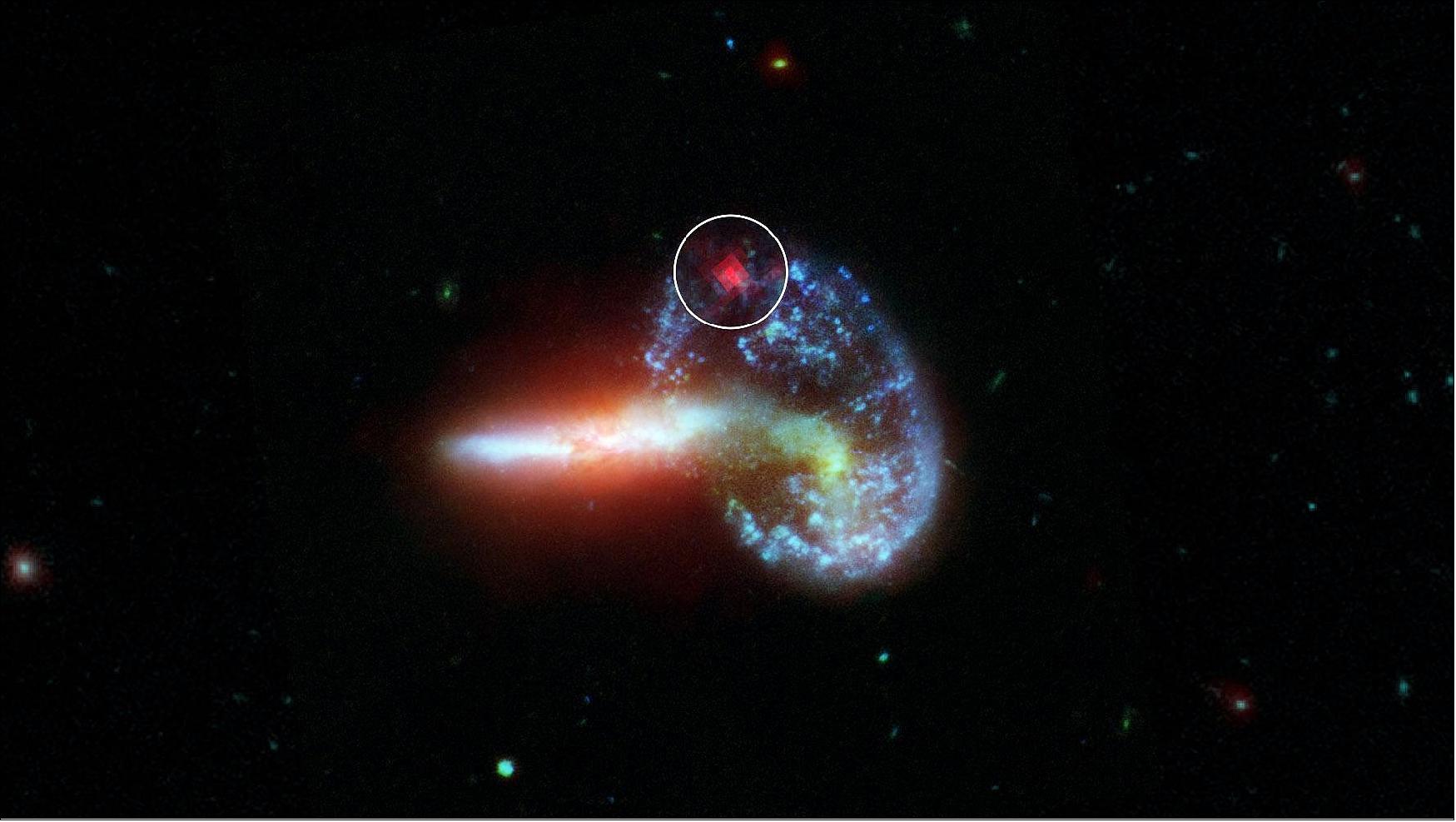 Figure 12: This image shows galaxy Arp 148, captured by NASA's Spitzer and Hubble telescopes. Inside the white circle is specially-processed Spitzer data, which reveals infrared light from a supernova that is hidden by dust. Supernovae are massive stars that have exploded after running out of fuel. They radiate most brightly in visible light (the kind the human eye can detect), but these wavelengths are obscured by dust. Infrared light, however, can pass through dust. The analysis of Arp 148 was part of an effort to find hidden supernovae in 40 dust-choked galaxies that also emit high levels of infrared light. These galaxies are known as luminous and ultra-luminous infrared galaxies (LIRGs and ULIRGs, respectively). The dust in LIRGs and ULIRGs absorbs optical light from objects like supernovae but allows infrared light from these same objects to pass through unobstructed for telescopes like Spitzer to detect (image credit: NASA/JPL-Caltech)