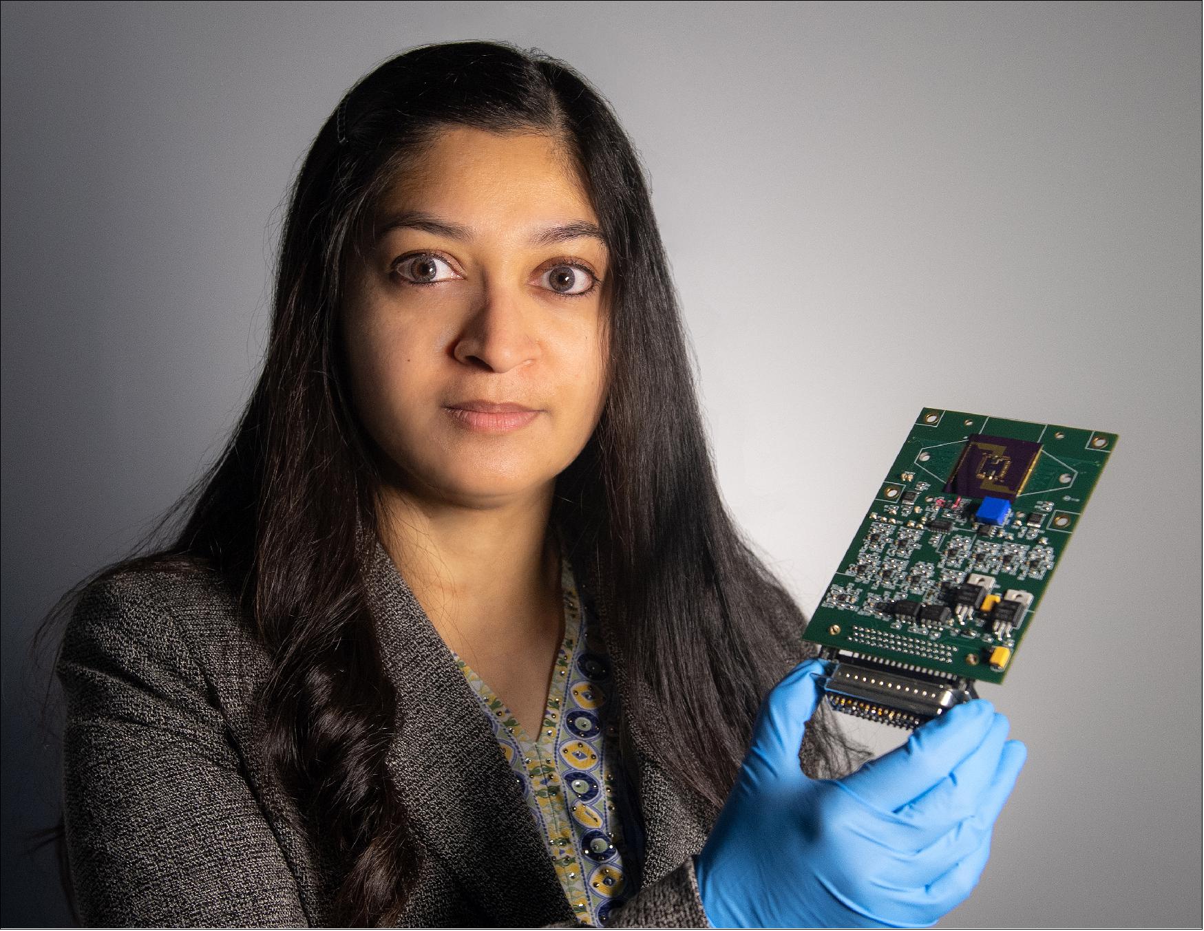 Figure 82: Technologist Mahmooda Sultana holds an early iteration of an autonomous multifunctional sensor platform, which could benefit all of NASA's major scientific disciplines and efforts to send humans to the Moon and Mars (image credit: NASA/W. Hrybyk)