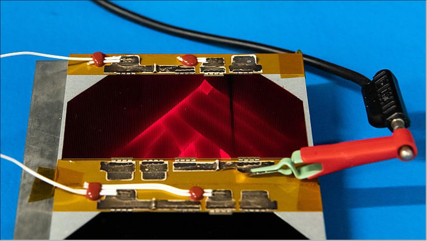 Figure 48: Made from the same kind of semiconductor materials as computer circuits, solar cells are designed so that incoming sunlight generates an electric current. But the process can be reversed for test purposes: apply an electric charge and a solar cell will glow (image credit: ESA–SJM Photography)