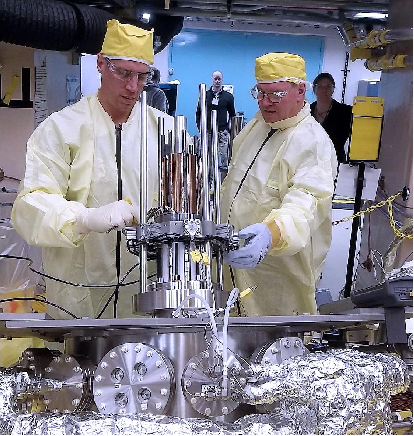 Figure 95: Marc Gibson, Kilopower lead engineer, and Jim Sanzi, Vantage Partners, install hardware on the Kilopower assembly at the Nevada National Security Site in March 2018 (image credit: NASA) 113)