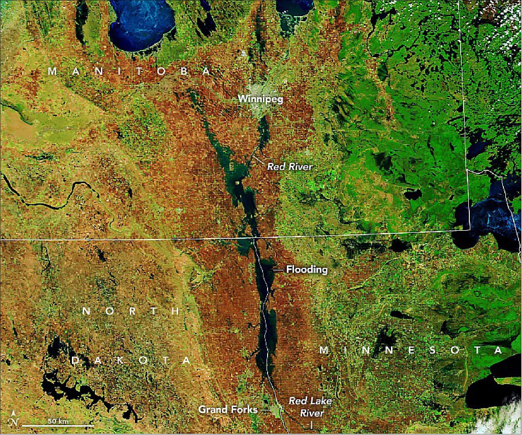 Figure 19: A blizzard, multiple rainstorms, and melting winter ice swelled rivers out of their banks and across a flat floodplain in Minnesota, North Dakota, and Manitoba. The false-color image was acquired with the MODIS instrument on NASA’s Terra satellite. This image shows the flooded valley as observed by Terra on May 10, 2022. The image combines shortwave infrared and visible light (MODIS bands 7-2-1) to better distinguish river water out of its banks (image credit: NASA Earth Observatory images by Lauren Dauphin, using MODIS data from NASA EOSDIS LANCE and GIBS/Worldview. Story by Michael Carlowicz)