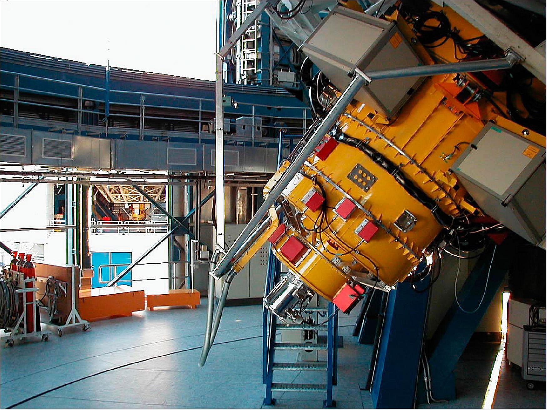 Figure 98: This photo shows the twin instruments, FORS2 at KUEYEN (in the foreground) and FORS1 at ANTU, seen in the background through the open ventilation doors in the two telescope enclosures. Although they look alike, the two instruments have specific functions (image credit: ESO) 145)