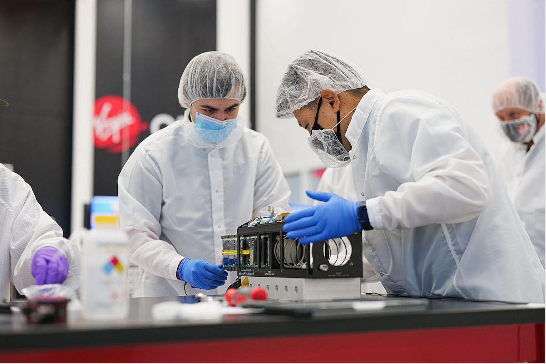 Figure 12: Payload technicians prepare one of the 10 CubeSats on the Launch Demo 2 mission for loading into its deployment mechanism (image credit: Virgin Orbit)