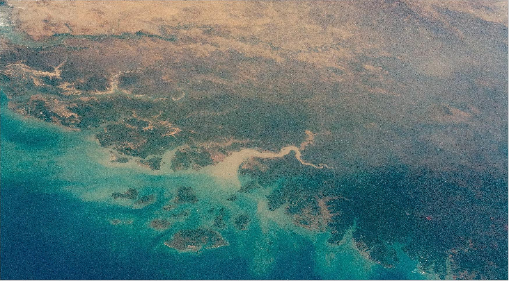 Figure 10: An astronaut aboard the International Space Station (ISS) took this oblique photograph that shows most of the West African country of Guinea-Bissau, along with neighboring Guinea, The Gambia and Senegal, and the southern part of Mauritania. This scene stretches from the green forest vegetation and wet climates of the Atlantic coast to the almost vegetation-less landscapes of the Sahara Desert (image credit: NASA)
